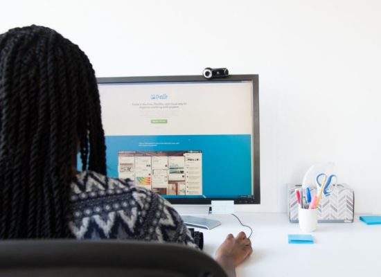 Woman setting up email campaigns to automate on laptop