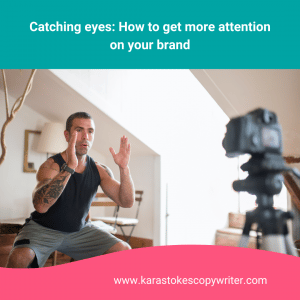 Man stands in a squat position with hands raised, facing a camera on a tripod.